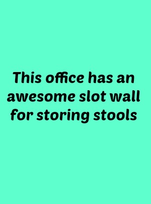 This office has an awesome slot wall for storing stools